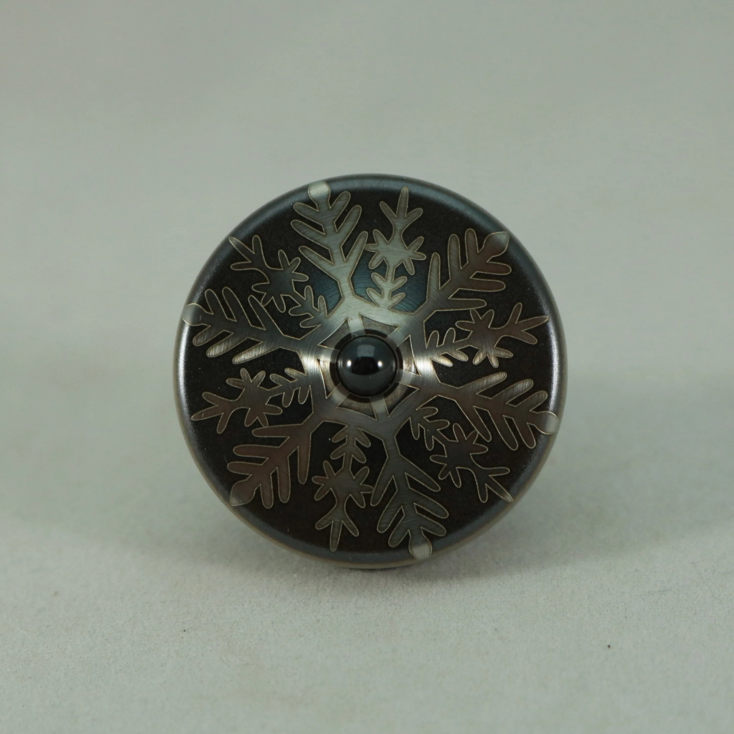 S2- Laser Etched  Inverted Snowflake on a Stainless Steel Spinning Top
